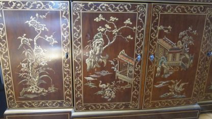 gilded painting of garden on asian cabinet