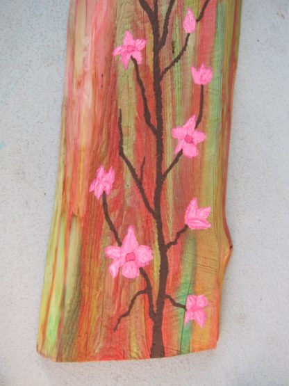 A close-up of the cherry blossoms painted on wood