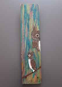 Two owls painted on wood