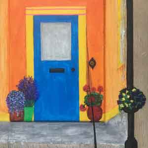 The blue door of an orange Irish cottage